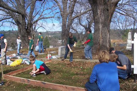 Scouts of Troop 460 help build a memorial flag pole at the Pleasant Valley Cemetery