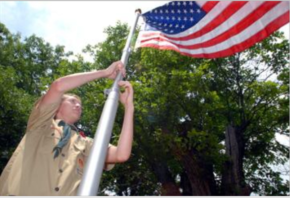 Eagle Scout Eric Hewitt raises an American Flag at the Pleasant Valley Cemetery 