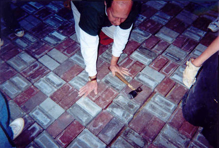 A Scoutmaster offering guidance to detail