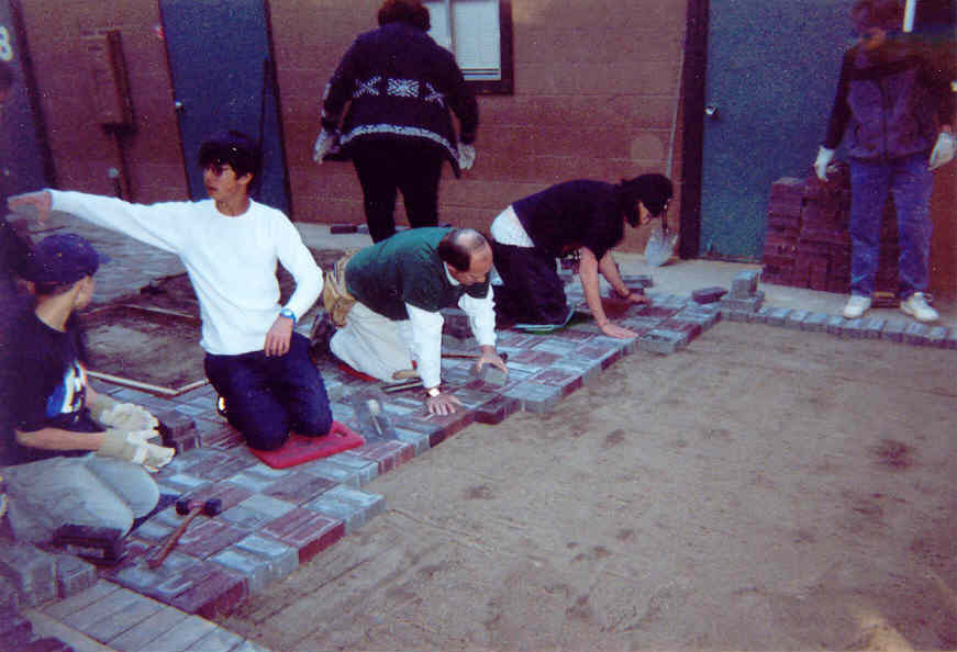 The assembly line begins! With myself and 3 assistants we begin laying the bricks down while the rest of the crew delivers the bricks closer to the site.