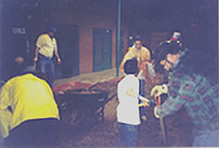 The scene darkens as the team speeds up spreading the fill