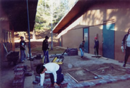 We start sweeping the sand over the bricks