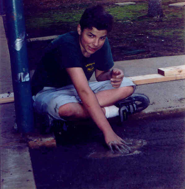 A Scout's hand in wet cement