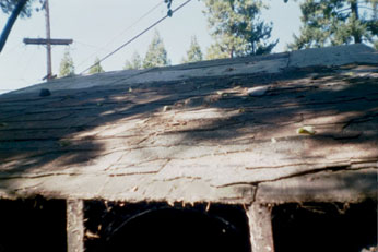 roofdamage.jpg sagging roof with missing shingles